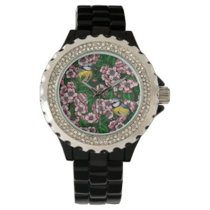 Montre Rameaux bleus dans le cerisier en fleurs en vert
