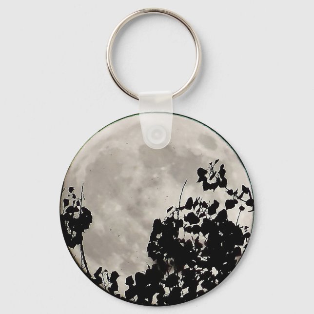 Moon behind dark leaves keychain (Front)