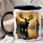 Moose in Autumn Lake Reflection Mug<br><div class="desc">Experience the serene beauty of nature with the Moose in Autumn Lake Reflection Mug. This stunning mug features a majestic moose standing in a tranquil lake surrounded by vibrant autumn foliage, with the beautiful colours and scenery reflected in the water. Customized with your name, it adds a personal and unique...</div>