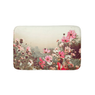 Morning light, blooming pink cosmos. bath mat