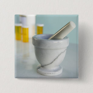 Mortar and pestle, pill bottles in background 2 inch square button