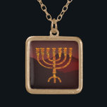 Moshe's Menorah Gold Plated Necklace<br><div class="desc">In the Torah Moshe Rabbenu is told, "You shall make a Menorah of pure gold, beaten out, shall the Menorah be made, its base, its branch, its goblets, its knobs, and its flowers shall be hammered from it, " [Shmot 25:31] and later, "See, and construct, according to their form that...</div>