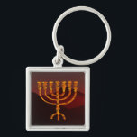 Moshe's Menorah Keychain<br><div class="desc">In the Torah Moshe Rabbenu is told, "You shall make a Menorah of pure gold, beaten out, shall the Menorah be made, its base, its branch, its goblets, its knobs, and its flowers shall be hammered from it, " [Shmot 25:31] and later, "See, and construct, according to their form that...</div>