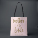 Mother of the Bride Gold Glitter Blush PInk Tote Bag<br><div class="desc">This Mother of the Bride tote bag is perfect for proud moms to tote around all their belongings at the bridal shower or the main event. This blush pink tote bag features faux gold glitter style lettering on the front. Personalize these totes with your wedding party member's name on the...</div>