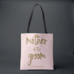 Mother of the Groom Gold Glitter Blush PInk Tote Bag<br><div class="desc">This Mother of the Groom tote bag is perfect for proud moms to tote around all their belongings at the bridal shower or the main event. This blush pink tote bag features faux gold glitter style lettering on the front. Personalize these totes with your wedding party member's name on the...</div>