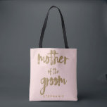 Mother of the Groom Gold Glitter Blush PInk Tote Bag<br><div class="desc">This Mother of the Groom tote bag is perfect for proud moms to tote around all their belongings at the bridal shower or the main event. This blush pink tote bag features faux gold glitter style lettering on the front. Personalize these totes with your wedding party member's name on the...</div>
