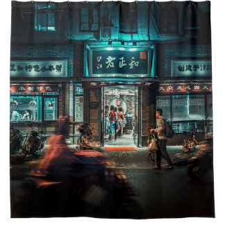 MOTORCYCLES AND PEOPLE PASSING BY AT NIGHT TIME