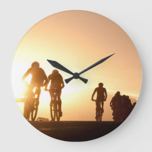 Mountain Bike Riders Make Their Way Over The Top Large Clock