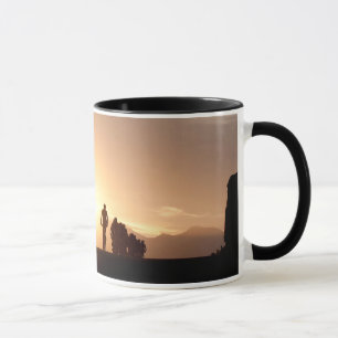 Mountain Bike Riders Make Their Way Over The Top Mug