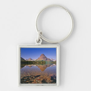 Mountains reflect into calm Two Medicine Lake in Keychain