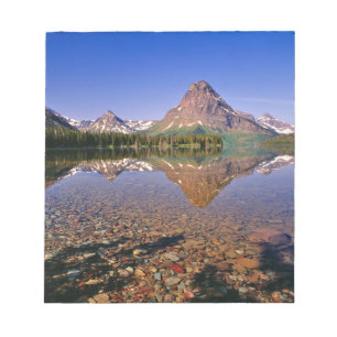 Mountains reflect into calm Two Medicine Lake in Notepad