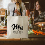 Mrs Minimalist Modern Black Script Newlywed Tote Bag<br><div class="desc">Embrace modern elegance with our Mrs Minimalist Modern Black Script Newlywed Tote Bag. This sleek and stylish tote bag features a minimalist design with "Mrs" in bold black script, celebrating your newlywed status with contemporary flair. Crafted with durable materials and spacious enough for all your essentials, this tote bag is...</div>