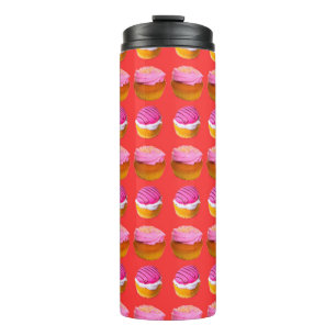 Muffins, cupcakes with white and pink cream on a r thermal tumbler