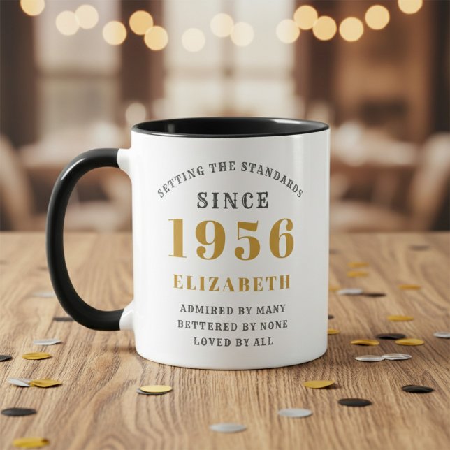 Mug 70th Birthday 1956 Add Name Elegant (Born 1956 birthday gift mug. Wood table, blurred background.)