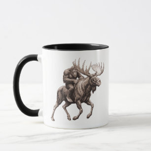 Mug Bigfoot à cheval sur un orignal