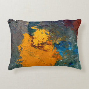 multi-colored strokes of oil paint on the artist's accent pillow