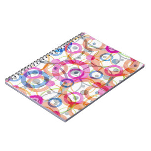 Multi-coloured polka dots, circles on a white notebook