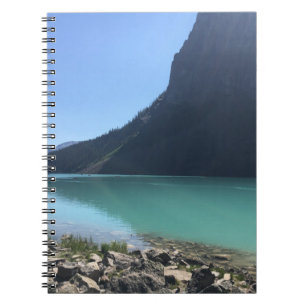 MULTICOLORED CANOES MOORED IN DOCK IN LAKE NOTEBOOK