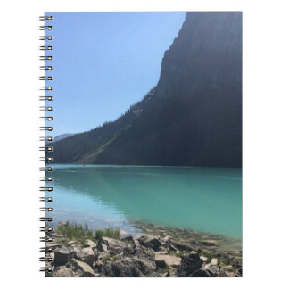 MULTICOLORED CANOES MOORED IN DOCK IN LAKE NOTEBOOK