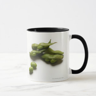multiple green edamame beans with pea pod broken mug
