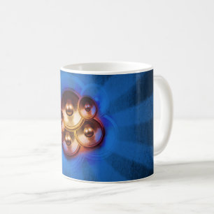 Music speakers and blue sunburst coffee mug