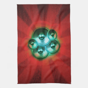 Music speakers and red sunburst kitchen towel