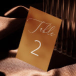 Mustard Brown Minimalist Script Fall Wedding Table Number<br><div class="desc">This elegant wedding table number card features a rich mustard brown background paired with delicate white script and bold numbering for a clean, modern look. The warm spiced ochre tone gives it an inviting, earthy feel - perfect for autumn weddings, rustic receptions, or cozy outdoor celebrations. Minimalist yet eye catching,...</div>