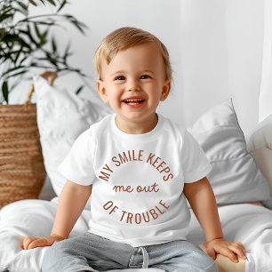 My smile keeps me out of trouble baby T-Shirt