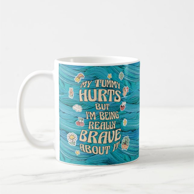 MY TUMMY HURTS BUT I'M BEING REALLY BRAVE ABOUT IT COFFEE MUG (Left)