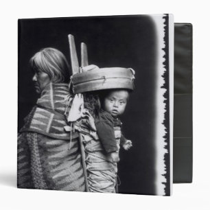 Navaho woman carrying a papoose on her back binder