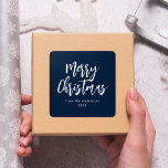 Navy and White Brush Script Merry Christmas Square Sticker<br><div class="desc">Modern holiday stickers featuring "Merry Christmas" displayed in white brush script lettering with a navy background. Personalize the simple Merry Christmas stickers with your name and year in white lettering. The navy Christmas stickers are perfect for sealing holiday envelopes,  party favor bags,  and gifts.</div>