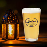 Navy Blue Stylized Wedding Groomsman Name Glass<br><div class="desc">Beer glass for the wedding groomsman that features his name printed in a trendy, navy blue, stylized script inside a navy blue colour oval border along with wedding date. A great party supply idea for a bachelor party! Personalize your beer glass by editing and replacing name and date with your...</div>