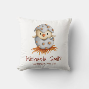 Neutral baby with a bird hatching from its egg throw pillow