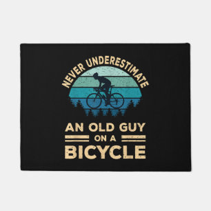 Never Underestimate An Old Guy On A Bicycle Funny Doormat