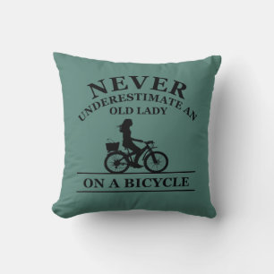 Never underestimate an old lady on a bicycle throw pillow