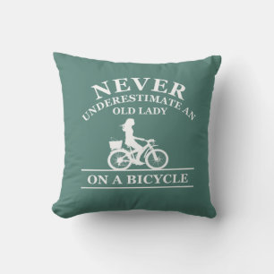 Never underestimate an old lady on a bicycle throw pillow