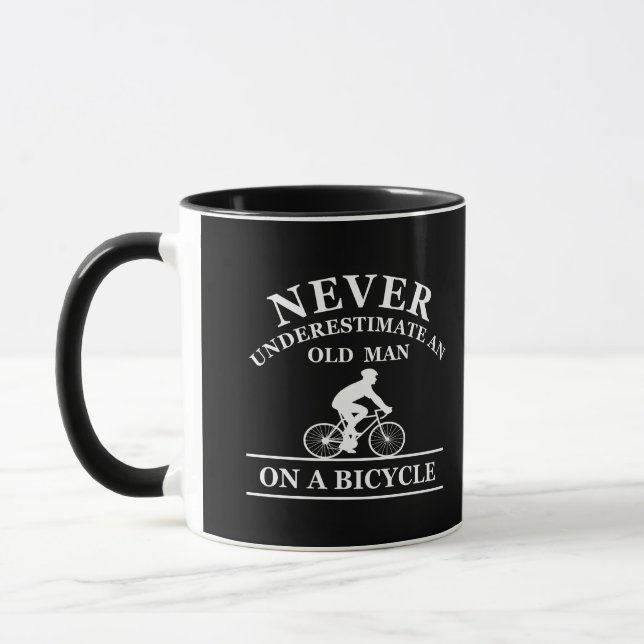 never underestimate an old man on a bicycle mug (Left)