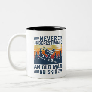 never underestimate an old man on skis Two-Tone coffee mug