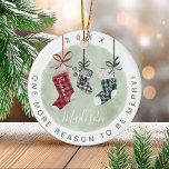 New Baby Keepsake Watercolor Family Stockings Ceramic Ornament<br><div class="desc">Special keepsake ornament for the arrival of your new baby this Christmas season with our beautiful and festive Christmas pregnancy keepsake holiday ornament. Our design features our hand-painted watercolor plaid pattern hanging Christmas stockings in red, green, and black. Each of the Christmas stockings is customized with the parent's name. The...</div>
