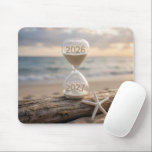 New Year 2027 Hourglass on Driftwood Log Mouse Pad<br><div class="desc">A sand timer sits on a weathered driftwood log by the beach,  showing the years 2026 and 2027,  next to a white starfish,  as a serene ocean and sky stretch out in the background</div>