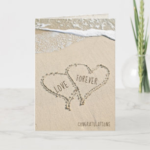 Newlyweds beach hearts in sand with surf card