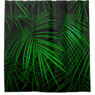Night in tropical rainforest. Palm leaves lit with