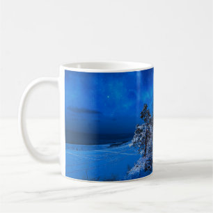 Nighttime winter scene with snow covered pines coffee mug