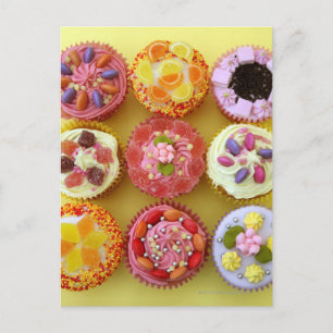 Nine cupcakes each decorated with candy in a postcard