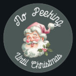 No peeking until Christmas fun pink Santa Classic Round Sticker<br><div class="desc">No peeking until Christmas featuring a smiling Santa with a pink hat.</div>
