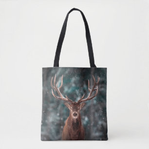 Noble deer male in winter snow forest. Artistic wi Tote Bag