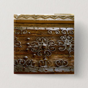 Norman iron scroll work on wooden door 2 inch square button