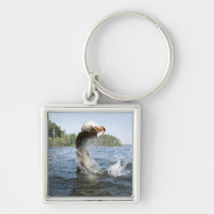 Northern Pike jumping out of water in a lake. Keychain