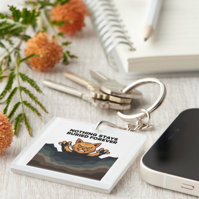 "NOTHING STAYS BURIED FOREVER" Orange Cat  Keychain (Front Right)