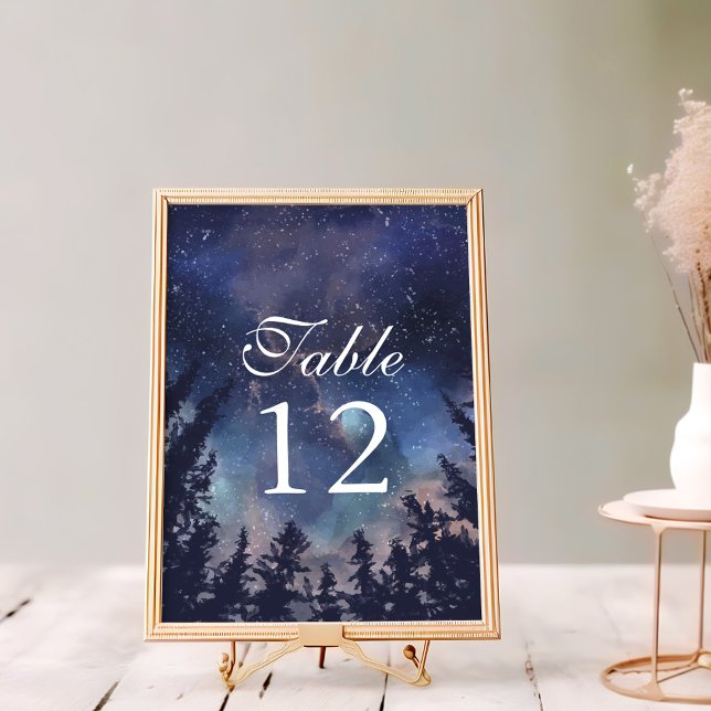 Numéro de table du Mariage de la forêt de nuit éto (Starry Night Forest Wedding Table Numbers on a white wooden table in a golden frame.)